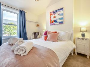 a bedroom with a large bed with a window at 3 Bed in Keswick 89526 in Keswick