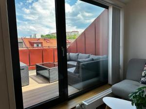 a living room with a view of a balcony at Luxury Apartment With Private Terrace in Gothenburg