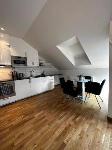 a kitchen and dining room with a table and chairs at Luxury Apartment With Private Terrace in Gothenburg