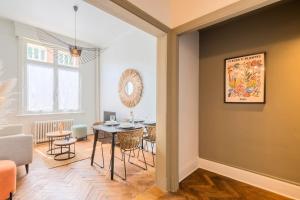 een eetkamer met een tafel en stoelen in een kamer bij Charming and comfortable apartment near tramway in Marcq-en-Baroeul