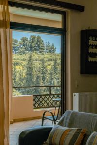 a living room with a large window with a view at Villa Kalamitsi Luxury Villa in Apokorona Xania in Kariá