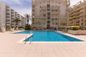 a swimming pool in front of a large apartment building at NOVELTY III Arysal 3 in Salou