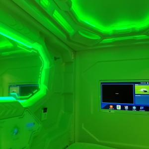 a green room with a computer monitor and a green ceiling at Cosmos capsule coworking London in London