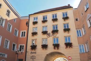 a building with a bike on the side of it at Hotel Mühldorf in Mühldorf