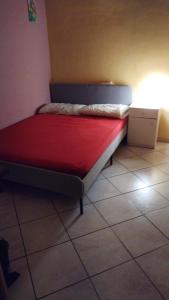 a small bed in a room with a red mattress at Lina House in Giardini Naxos