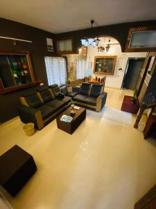 a living room with a couch and a table at Vibes of Varkala Homestay in Varkala