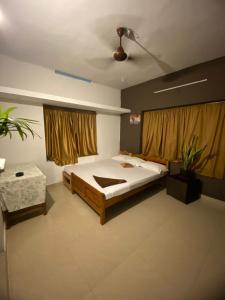 a bedroom with a bed and a ceiling at Vibes of Varkala Homestay in Varkala