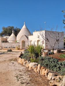 a house with two turrets and a yard with plants at Residenza Anima Mediterranea in Francavilla Fontana