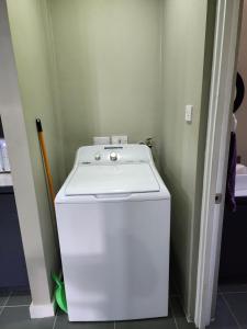 a white washer and dryer in a small room at Cozy 1-bedroom apartment in Frequente, St. George 