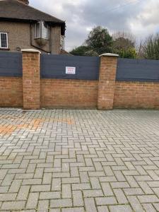 a brick fence in front of a house at Annex D. One Bedroom flat in south London in Carshalton