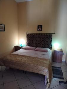 a bedroom with a large bed with two night stands at Lina House in Giardini Naxos