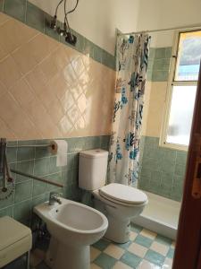 a bathroom with a toilet and a sink at Lina House in Giardini Naxos
