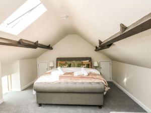 a bedroom with a large bed in a attic at The Apple Loft at Jordan House in Weymouth