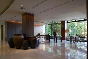 a lobby with tables and vases on the floor at Hyatt Regency Hakone Resort and Spa in Hakone