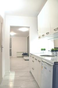 a kitchen with white cabinets and a counter top at Nice and comfy studio close to Old town and metro. in Warsaw