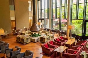 a large room with chairs and tables and windows at Hyatt Regency Hakone Resort and Spa in Hakone