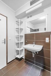 a bathroom with a sink and a mirror at Aparthotel Panorama in Bad Soden-Salmünster