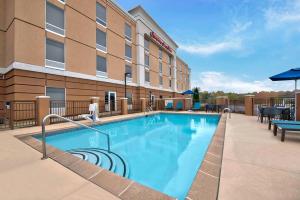 a hotel swimming pool in front of a hotel at Hampton Inn & Suites Jackson in Jackson