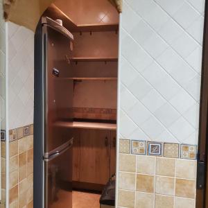 a kitchen with a refrigerator in a room at VUT Casa abuela Antonia in El Barco de Ávila