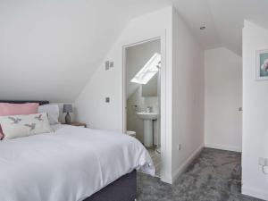 a white bedroom with a bed and a sink at 1 bed property in Paignton 82557 in Paignton
