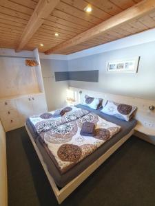 a large bed with pillows on it in a room at Haus Idili in Sankt Gallenkirch