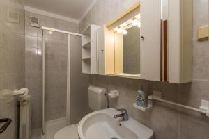 a bathroom with a sink and a toilet and a mirror at Apartment Nada 1202 in Banjole