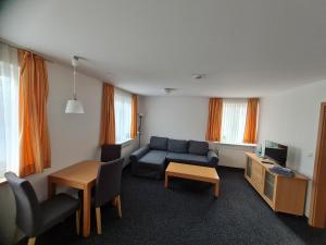 a living room with a couch and a table at Arp's Gasthof in Schönkirchen