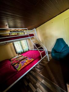 a room with two bunk beds and a chair at Casspo bunk bed in Devikolam