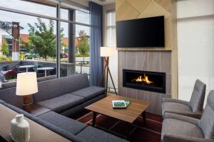 a living room with a couch and a fireplace at Hyatt Place Boise-Meridian in Meridian