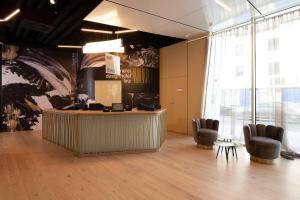 a lobby with a reception desk and chairs at Best Western Hotel Spinnerei Linz in Linz