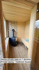 a small room with a woodburning stove in a cabin at Moon Lake Bicaz - Casa Imero in Buhalniţa
