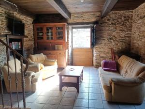 a living room with two couches and a table at CASA DA RIBEIRA in Quiroga