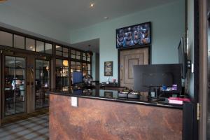 a bar in a hotel room with a counter at The Saxon Crown Wetherspoon in Corby