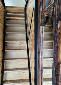 a staircase in a cabin with wood paneling at Gudauri Glamping in Gudauri