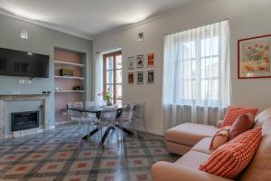 a living room with a couch and a table at Luxury For Groups & Families in city center in Turin