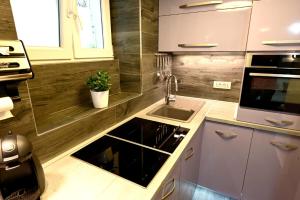 a kitchen with a sink and a counter top at Bel-Art in Hvar +2 photos