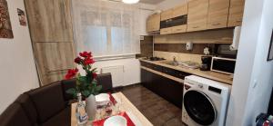 a small kitchen with a sink and a microwave at WhiteHouse in Popeşti-Leordeni