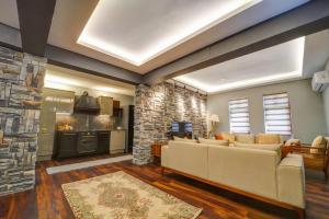 a living room with a couch and a stone fireplace at Kerem ile Aslı Butik Hotel in Melikgazi