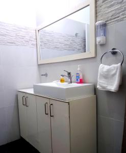 a bathroom with a white sink and a mirror at SPIRIT OF INDIA in Lagos