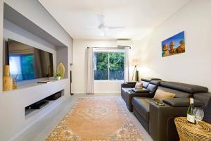 A television and/or entertainment centre at 'Infinity's Edge' Darwin Luxury Waterfront Oasis