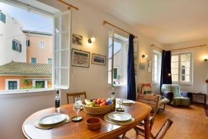 a dining room with a table with a bowl of fruit on it at Iliokambida house in Corfu
