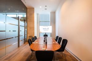 a conference room with a wooden table and chairs at Melia Valencia in Valencia