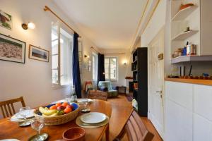a kitchen with a table with a bowl of fruit on it at Iliokambida house in Corfu