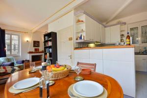a kitchen with a wooden table with plates on it at Iliokambida house in Corfu