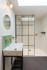 a bathroom with a shower and a sink at The Outbuilding Appledore in Snargate