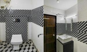 bagno con parete a scacchi in bianco e nero di FabHotel 19 West a Nuova Delhi
