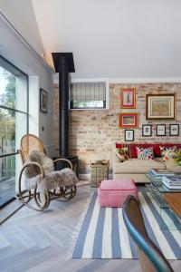 a living room with a couch and a fireplace at The Outbuilding Appledore in Snargate