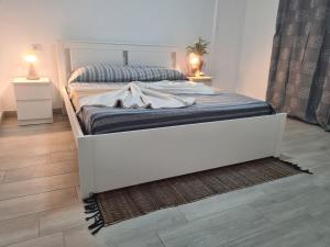 a bedroom with a large bed and two night stands at summerland beach in Los Cristianos +56 photos