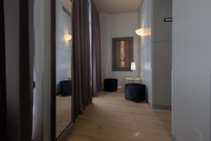 a hallway with a mirror and a table in a room at Art Hotel Olympic in Turin