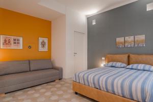 a bedroom with a bed and a couch at Luxury For Groups & Families in city center in Turin